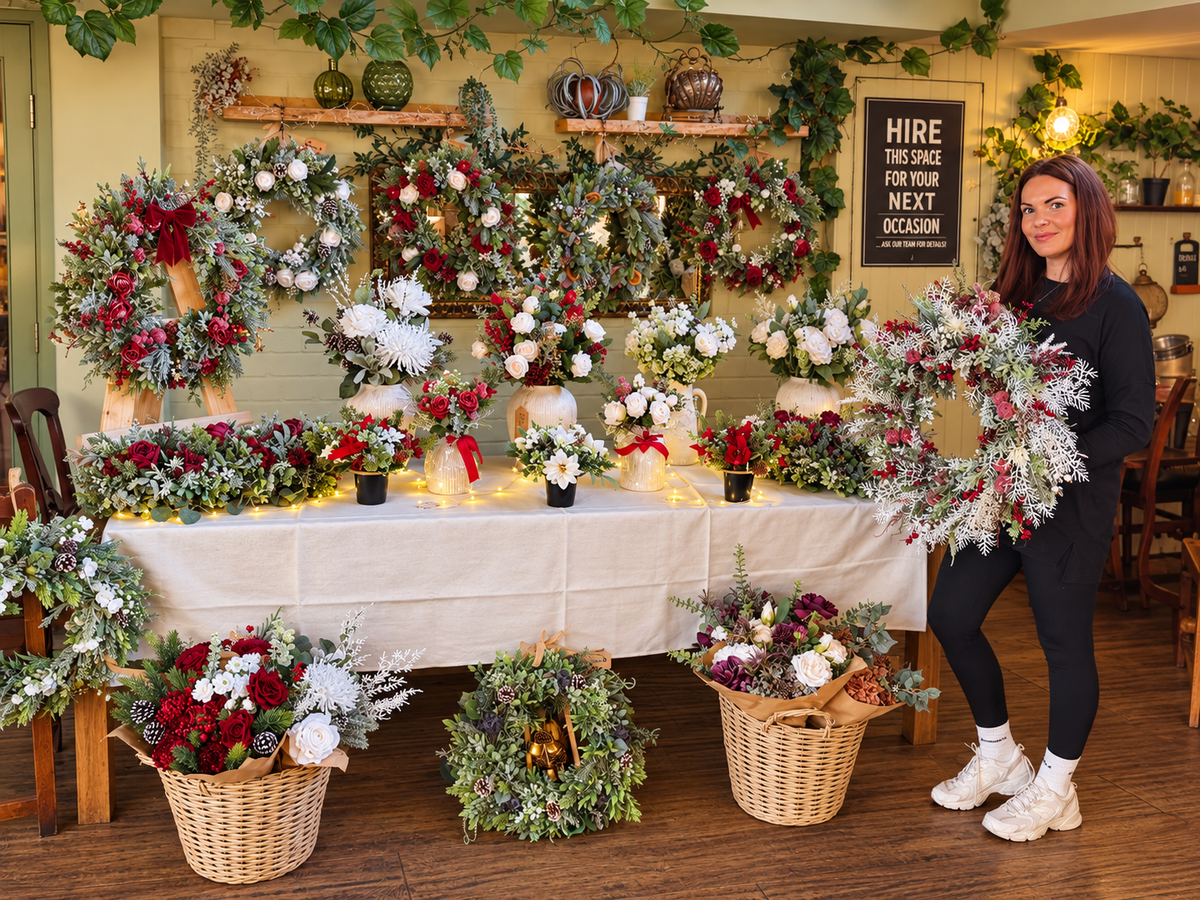 Rachel, founder of The Seasonal Wreath Company, with her handcrafted faux-floral wreaths and arrangements